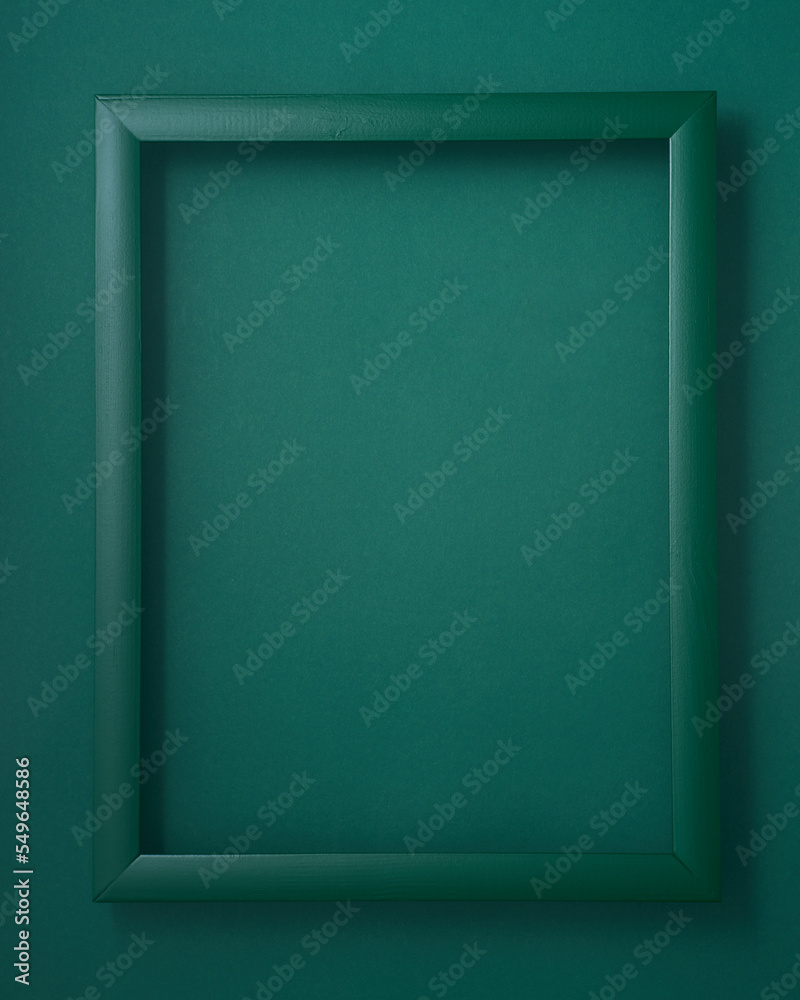 Wooden picture frame on green background Wooden picture frame on green background