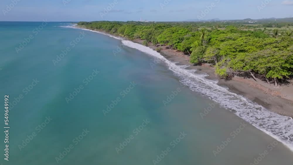 Ocean Waves Washing Up On The Sandy Shore Of Playa Palenque With Lush Green Trees In Summer In San Cristobal, Dominican Republic. - aerial Ocean Waves Washing Up On The Sandy Shore Of Playa Palenque With Lush Green Trees In Summer In San Cristobal, Dominican Republic. - aerial