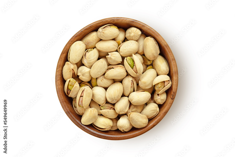 Pistachio nuts in wooden bowl on white background Pistachio nuts in wooden bowl on white background