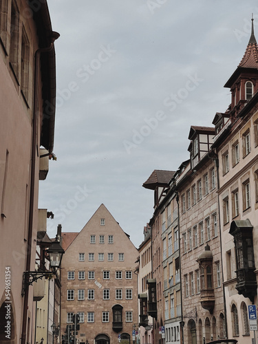 Old historic architecture in Nuremberg, Germany. Traditional European old town buildings with wooden windows, shutters and colourful pastel walls. Aesthetic summer vacation, tourism background © Floral Deco