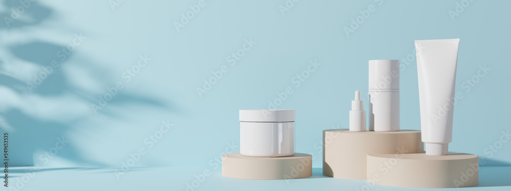 Fototapeta Group of white and blank, unbranded cosmetic cream jars and tubes on blue background. Skin care product presentation. Elegant mockup. Skincare, beauty and spa. Banner with copy space. 3D rendering.
