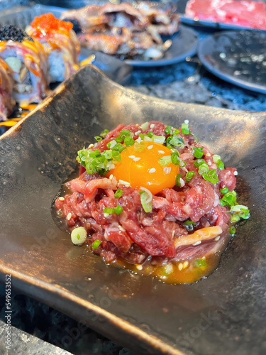 Japanese raw beef on top with yolk egg on black dish
in Japanese restaurant, Beef Tartare, Raw meat with Japanese style,  Japanese cuisine, Raw food , 
Japanese Steak tartare