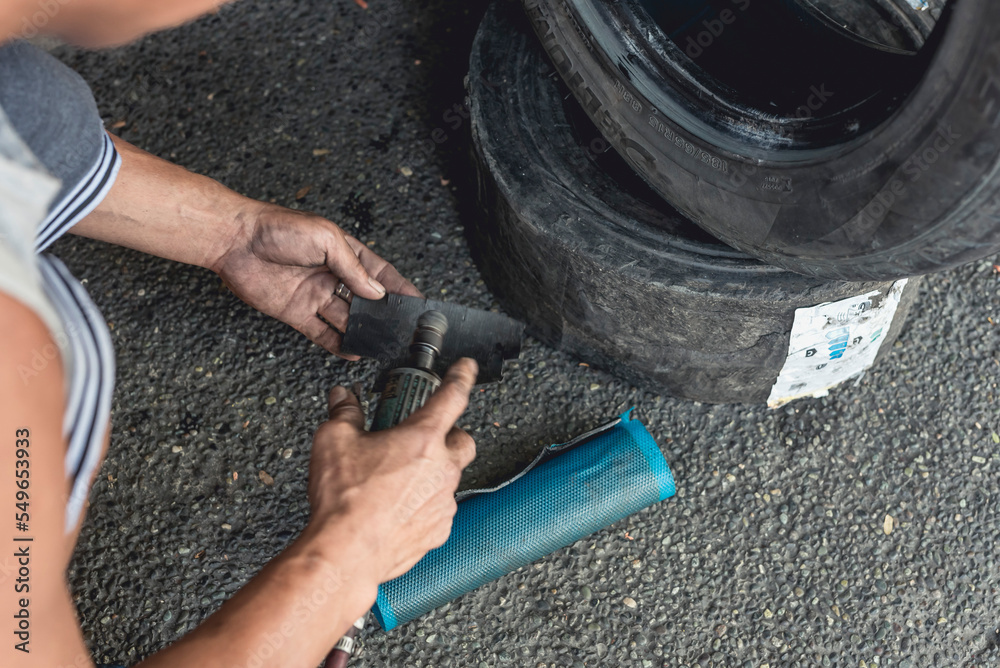 A man using an air die grinder with a sphere rotary burr to smoothen