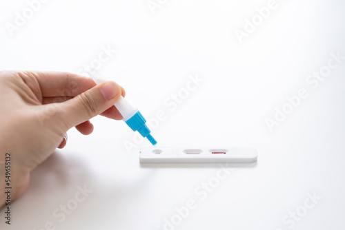woman holding a rapid antigen test kit