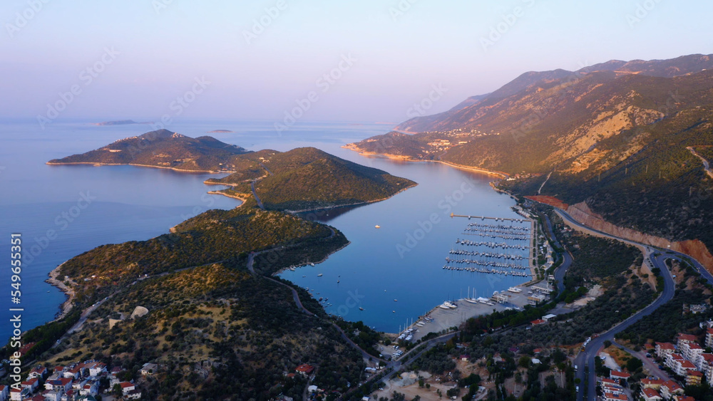 Aerial panoramic view from drone of sea bay surrounded by mountains. Top view of cityscape of resort town.