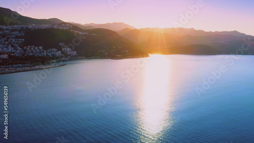 Aerial panoramic view of beautiful resort town on Mediterranean coast at sunset. Vacation concept.