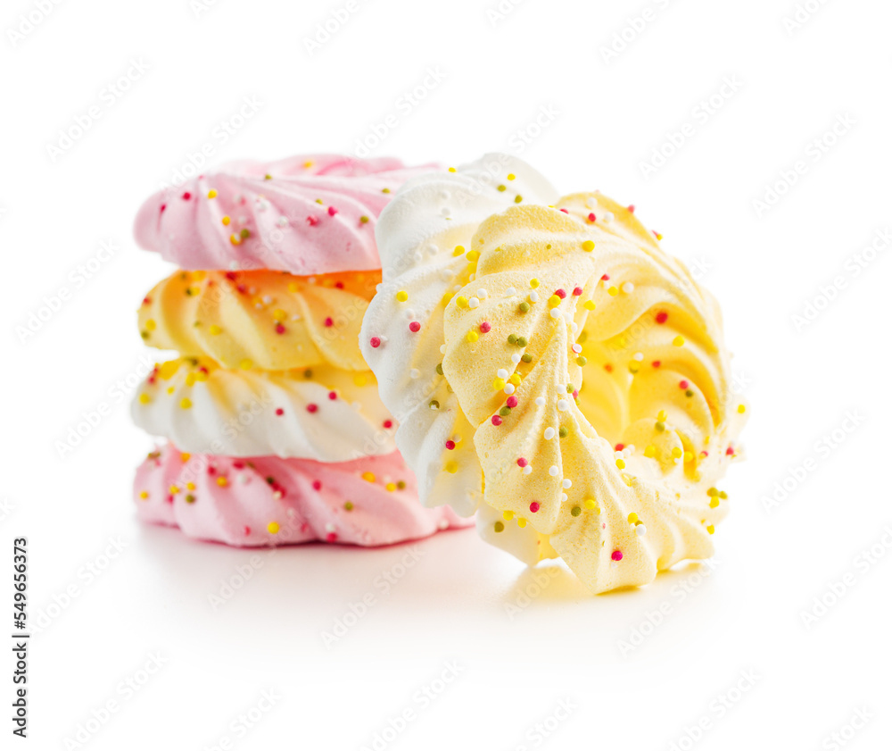 Different colors meringues with sprinkles isolated on white background. Different colors meringues with sprinkles isolated on white background.