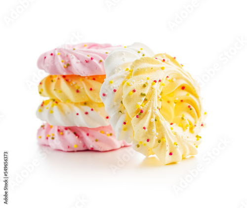 Different colors meringues with sprinkles isolated on white background.