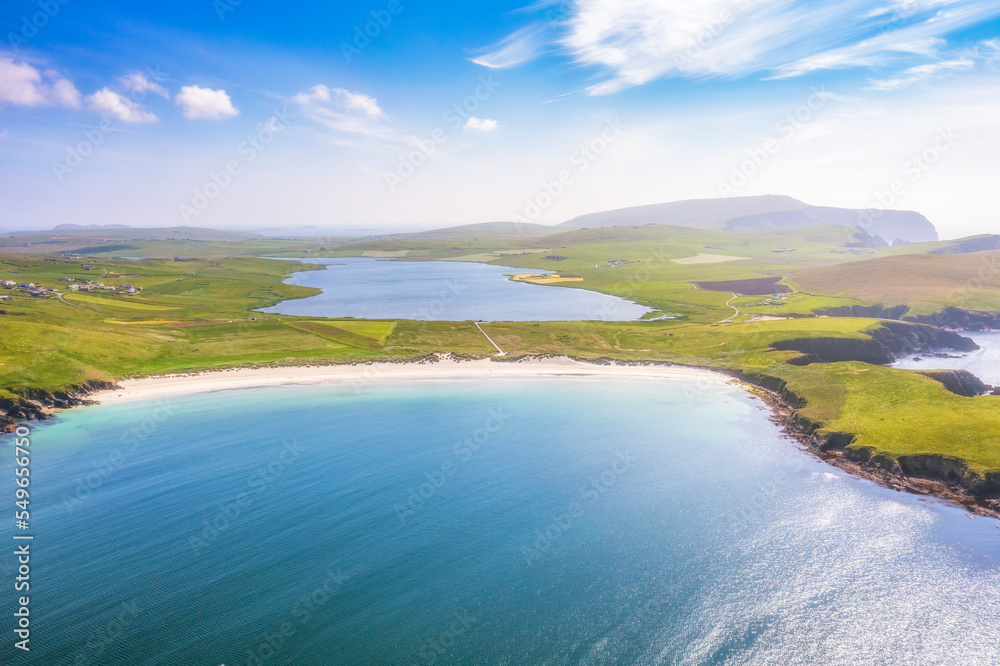 UK, Scotland, Aerial view of Scousburgh Sands in summer with Scousburgh Loch in background