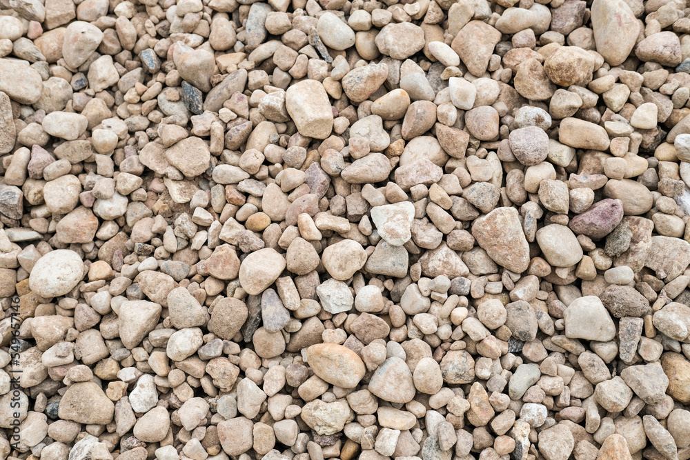 Abstract background with brown and beige dry stones, cobblestones, gravel. Gravel texture or background for design, for banner. Real grunge background texture and small stone. Close up, top view Abstract background with brown and beige dry stones, cobblestones, gravel. Gravel texture or background for design, for banner. Real grunge background texture and small stone. Close up, top view