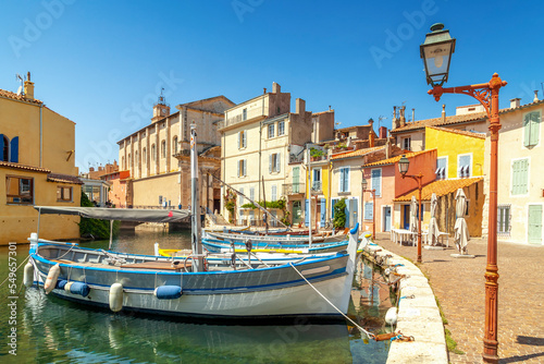 France, Provence-Alpes-Cote dAzur, Martigues, Boats moored along town canal photo