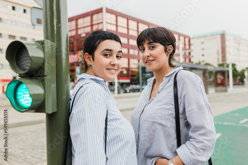 Young lesbian couple standing near stoplight