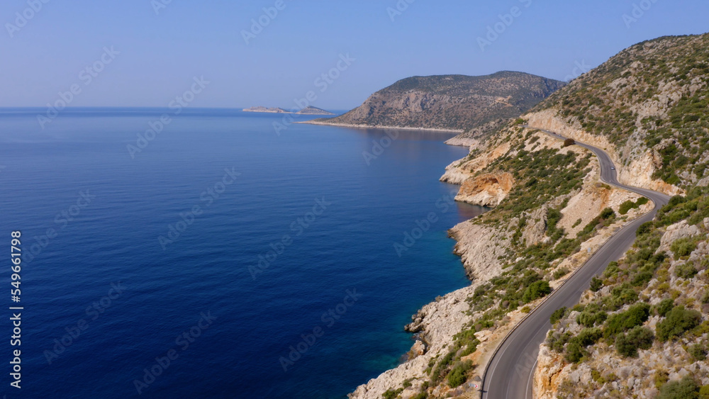 Spectacular view from drone of mountain road near the turquoise sea or ocean. Majestic nature landscape from above.