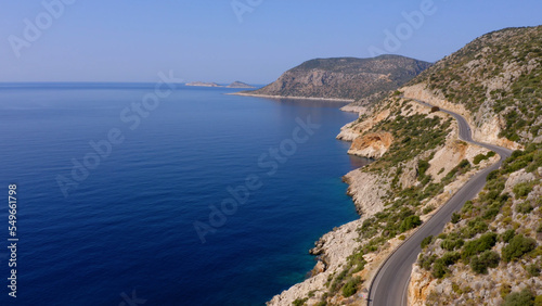 Spectacular view from drone of mountain road near the turquoise sea or ocean. Majestic nature landscape from above.