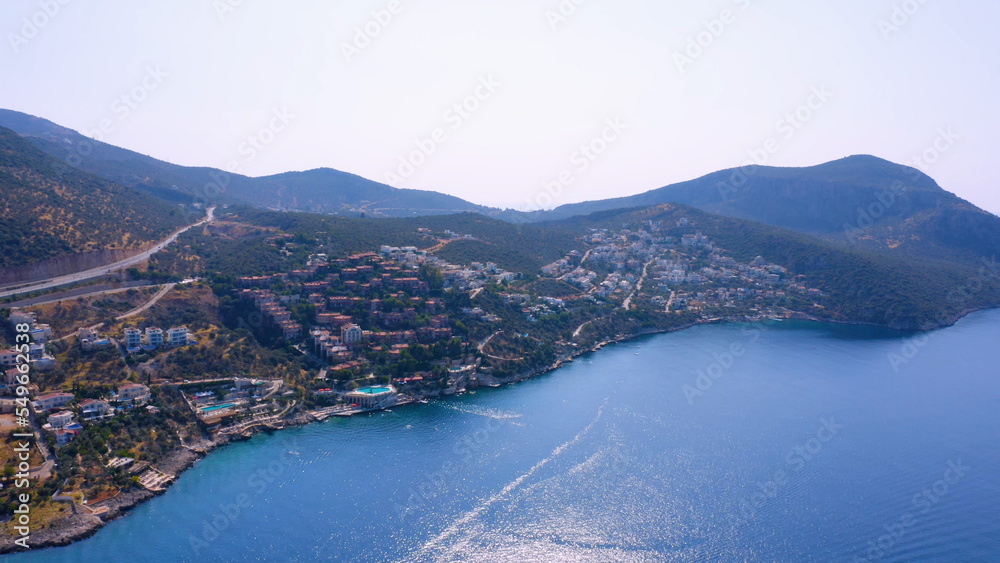 Top view of beautiful resort city by sea on the background of mountains. Panorama of coastal town.