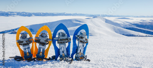 Winter hiking in the mountains. Snowshoes in snow with beautiful landscape