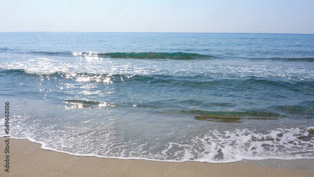 Sandy beach with sea waves. Beautiful seascape background. Nature landscape.