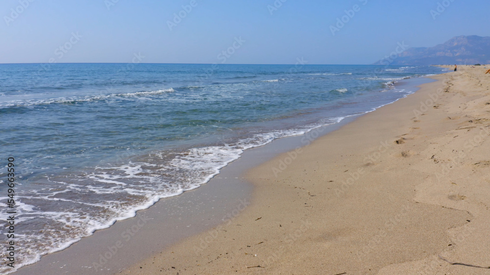 Blue sea waves on sandy beach. Nature background. Sea vacation concept.