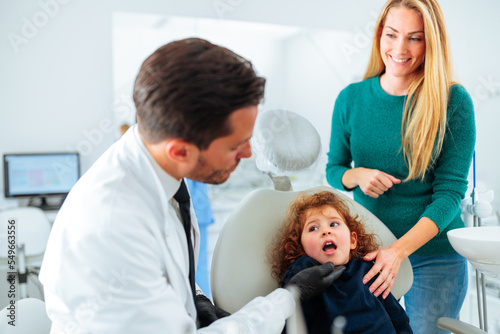 Child at dentist with mom.
