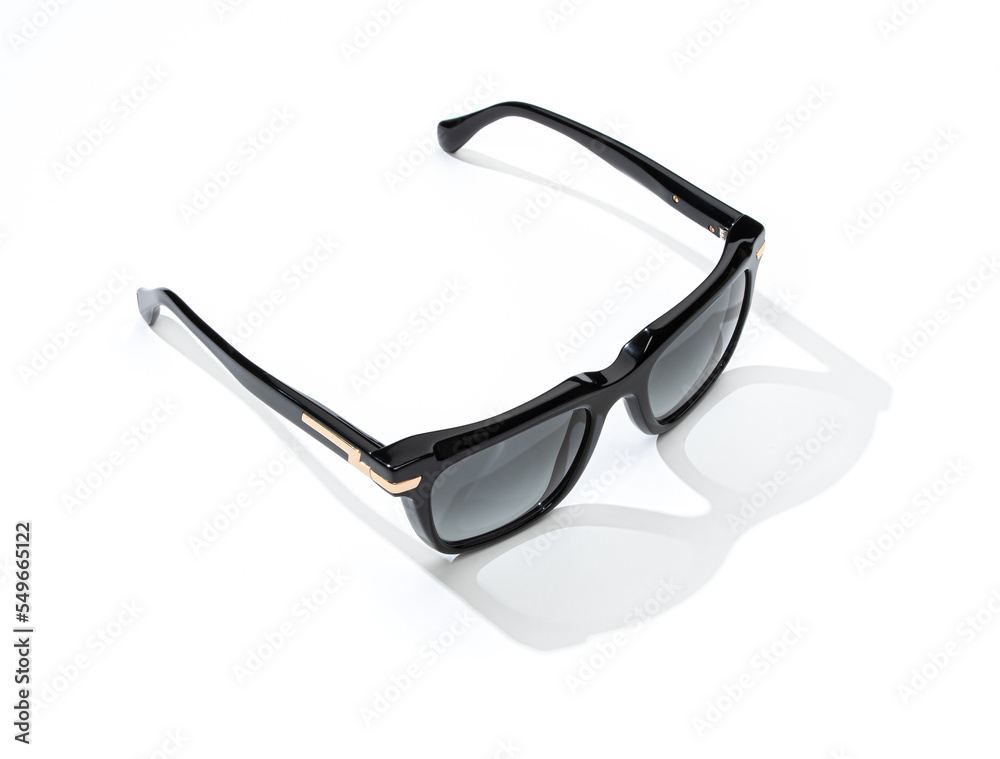 Fashion sunglasses in sunlight on summer yellow background. Woman stylish eyeglasses for banner. Female black glasses. Fashion sunglasses in sunlight on summer yellow background. Woman stylish eyeglasses for banner. Female black glasses.