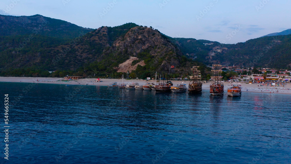 Beautiful aerial view from the sea to Kas coast and resort town. Green rocky mountains in the background.