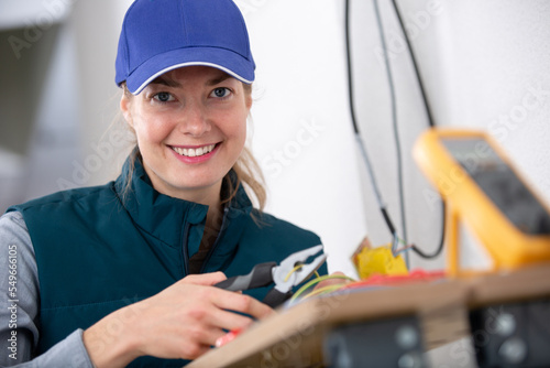 portrait of female electrician using wire cutters