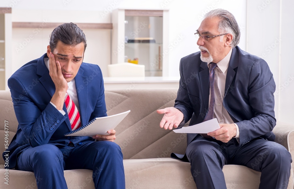Two businessman discussing business in office Two businessman discussing business in office