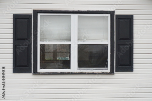 Double Window on White SIding with Black Shutters