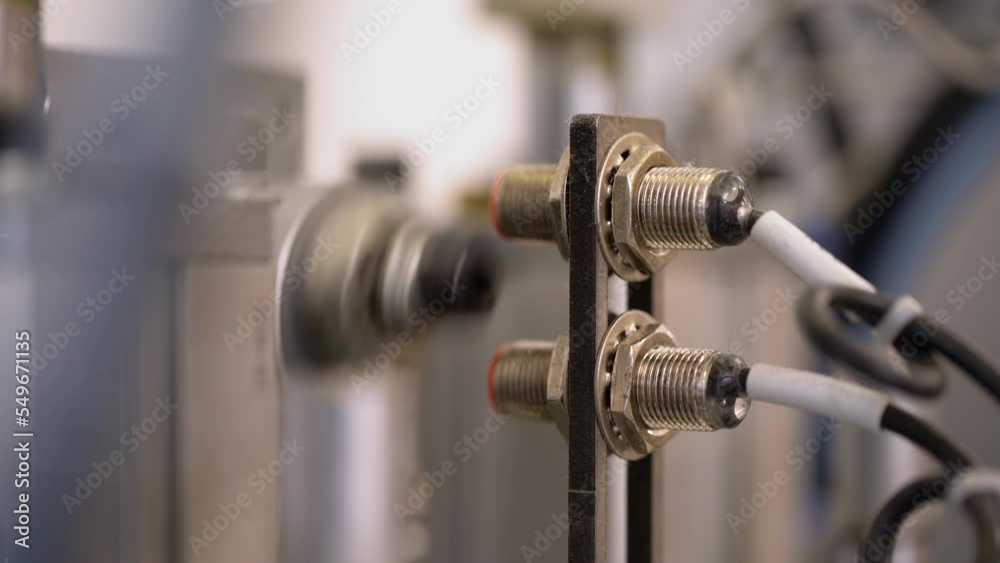Closeup of laser sensor of a factory machine. Automated assembly line. Closeup of laser sensor of a factory machine. Automated assembly line.