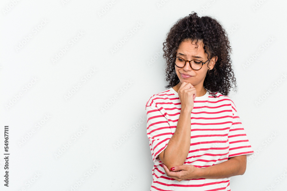 Young african american woman isolated looking sideways with doubtful and skeptical expression.