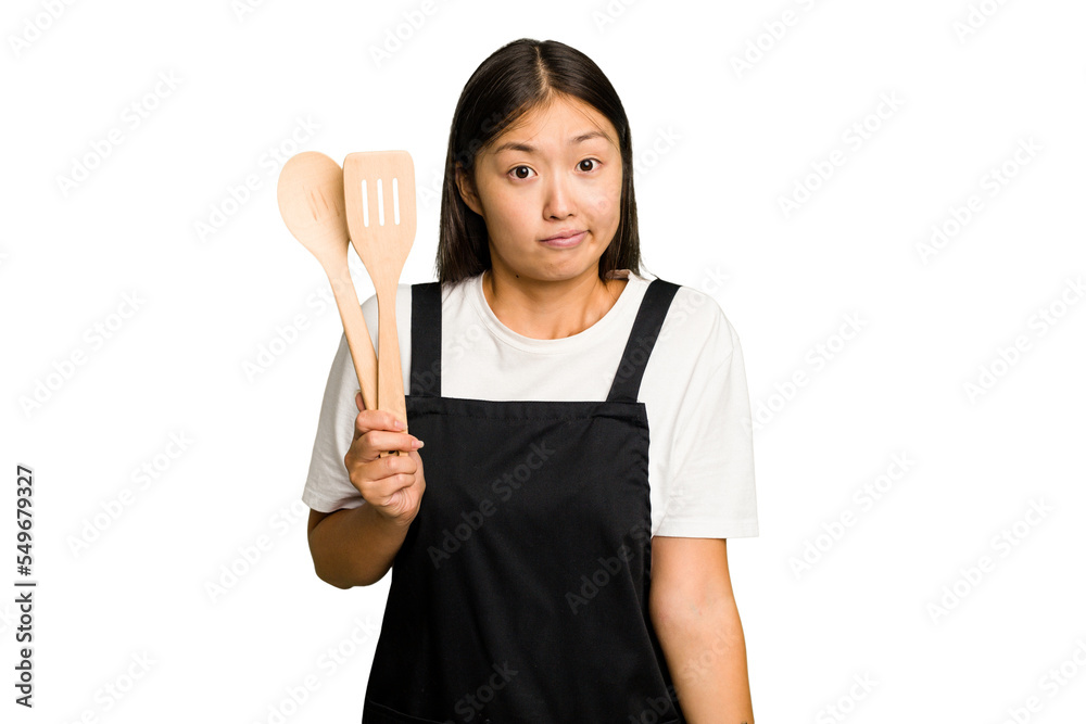 Young asian cook woman isolated shrugs shoulders and open eyes confused. Young asian cook woman isolated shrugs shoulders and open eyes confused.