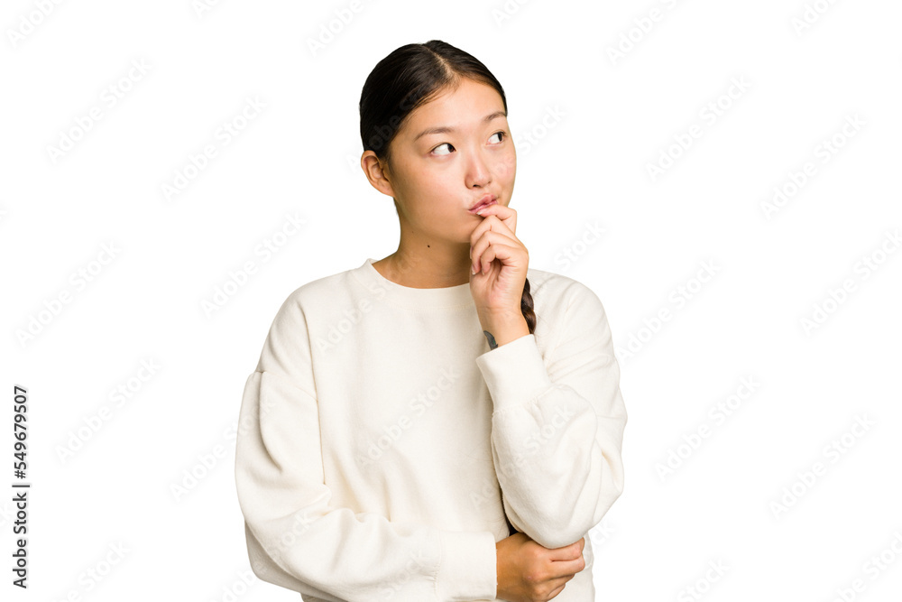 Young Asian woman isolated relaxed thinking about something looking at a copy space. Young Asian woman isolated relaxed thinking about something looking at a copy space.
