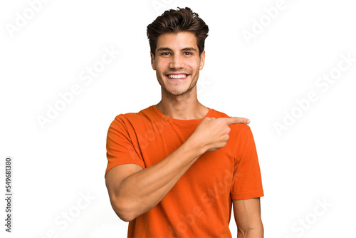 Young caucasian handsome man isolated smiling and pointing aside, showing something at blank space. photo