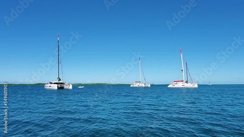 Crystal clear caribbean sea with ancored catamarans, Los Roques Archipelago photo