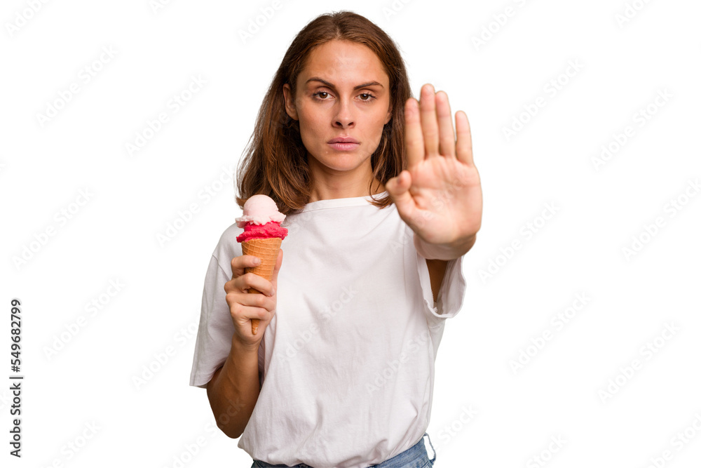 Young caucasian woman holding an ice cream isolated standing with outstretched hand showing stop sign, preventing you. Young caucasian woman holding an ice cream isolated standing with outstretched hand showing stop sign, preventing you.