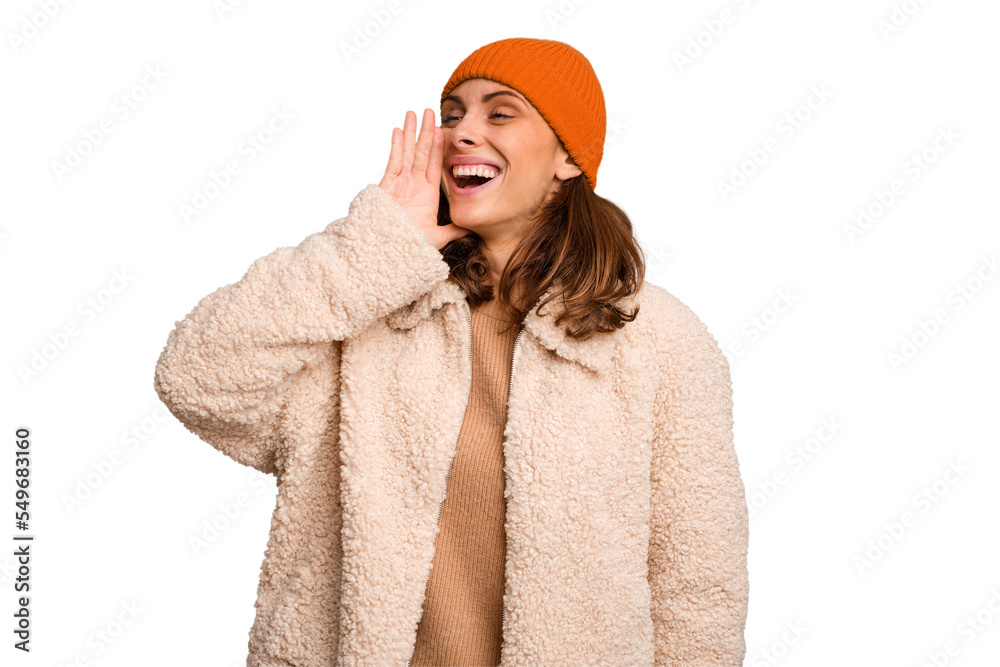 Young caucasian woman wearing winter clothes isolated shouting and holding palm near opened mouth. Young caucasian woman wearing winter clothes isolated shouting and holding palm near opened mouth.