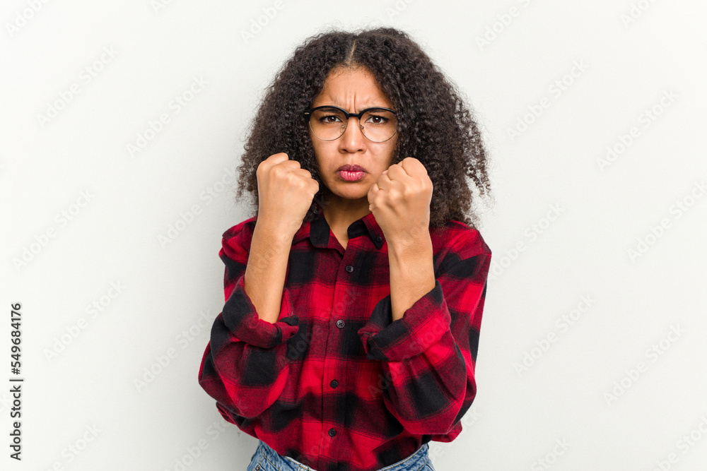 Young african american woman isolated on white background showing fist to camera, aggressive facial expression. Young african american woman isolated on white background showing fist to camera, aggressive facial expression.