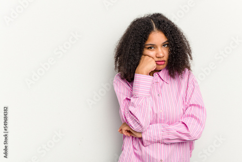 Young african american woman isolated on white background who feels sad and pensive, looking at copy space. © Asier