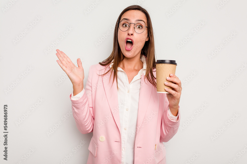 Business caucasian woman holding a take away coffee isolated on white background surprised and shocked. Business caucasian woman holding a take away coffee isolated on white background surprised and shocked.