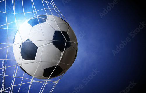 Soccer ball in goal on blue © Alekss