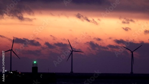 Copenhagen, Denmark Wind turbines at dawn spin over the Öresund straits. photo