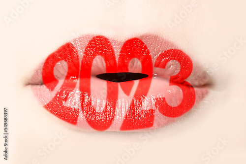 2023 written with red lipstick on girl lips
