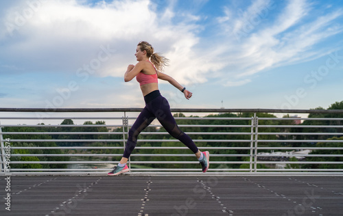 horizontal photo of strong woman running in the city, copy space, fitness concept