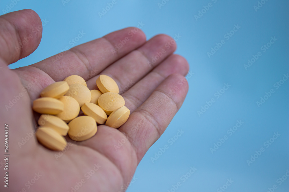 Yellow pills in hand Yellow pills in hand