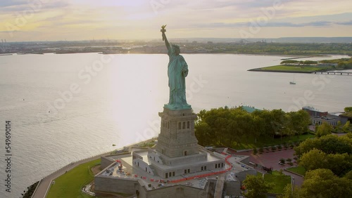 
Aerial Orbit of Statue of Liberty in Liberty Island, New York City. United States. This Magnificent Sculpture was designed by French sculptor Frédéric Auguste Bartholdi. Backlit. Shot from Helicopter photo