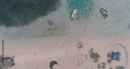 Drone shot tilt up caribbean sandbank, kitesurf camp on white sand beach, saky saky Los Roques