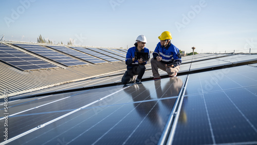 Renewable energy concepts.Electrical engineers are using laptops to monitor the operation of the solar rooftop.Engineering team working operation and maintenance in solar power plant in solar plant