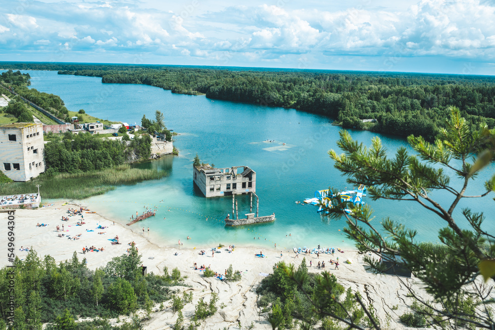 Rummu, Estonia. Abandoned prison located in small lake. Clear water and perfect location for paddle board surfing. Beach paradise