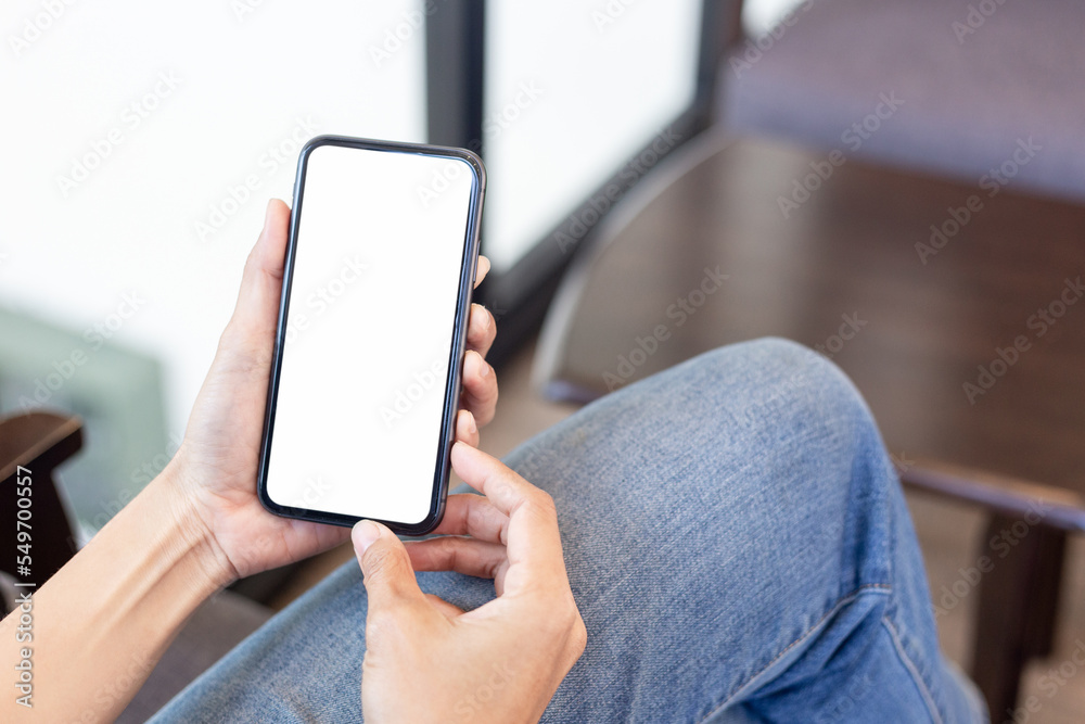 cell phone blank white screen mockup.hand holding texting using mobile on desk at office.background empty space for advertise.work people contact marketing business,technology