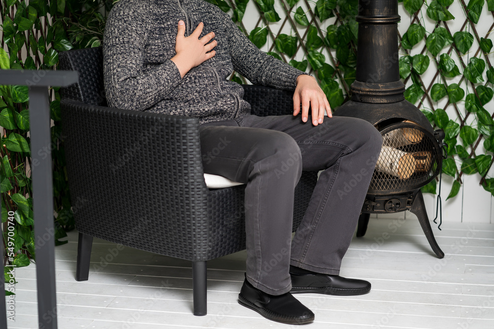 Chest pain and cough, man with lung ache in a room with stove heating Stock 写真 Adobe Stock